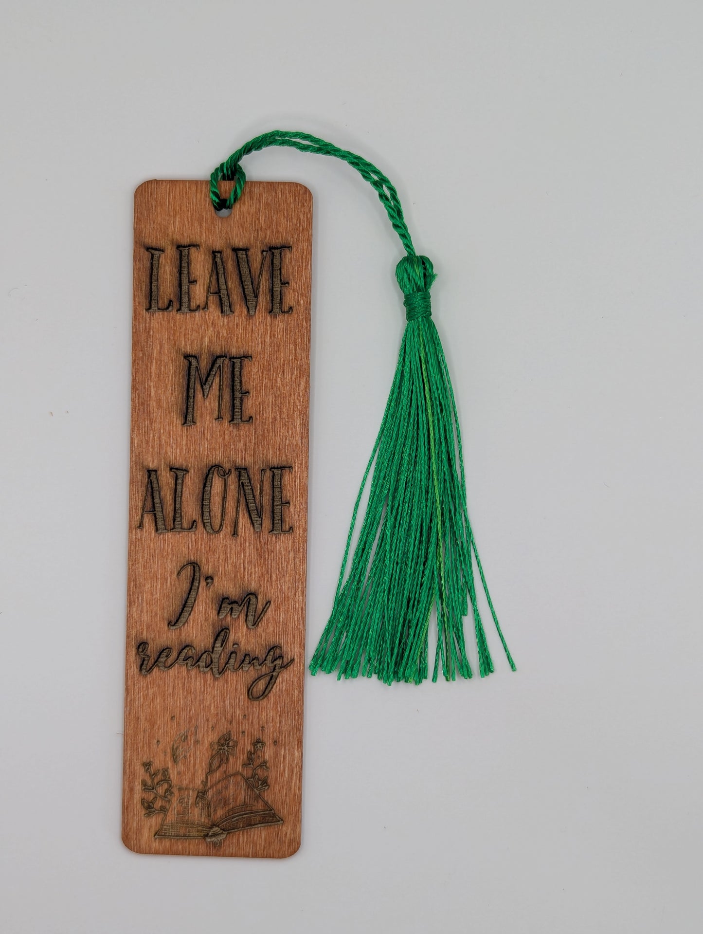 alt="Witty wooden bookmark engraved with ‘Leave Me Alone’"