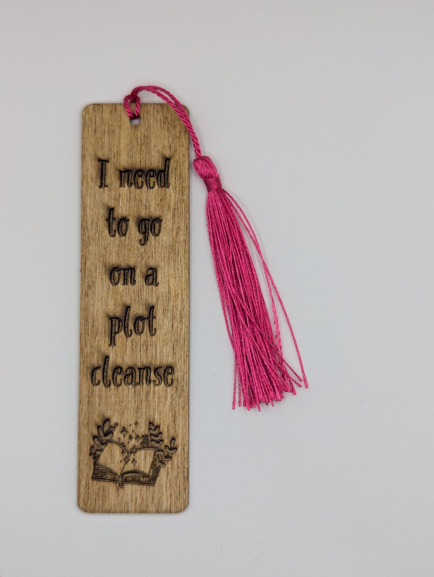 alt="Witty wooden bookmark engraved with ‘go on a Plot Cleanse’"