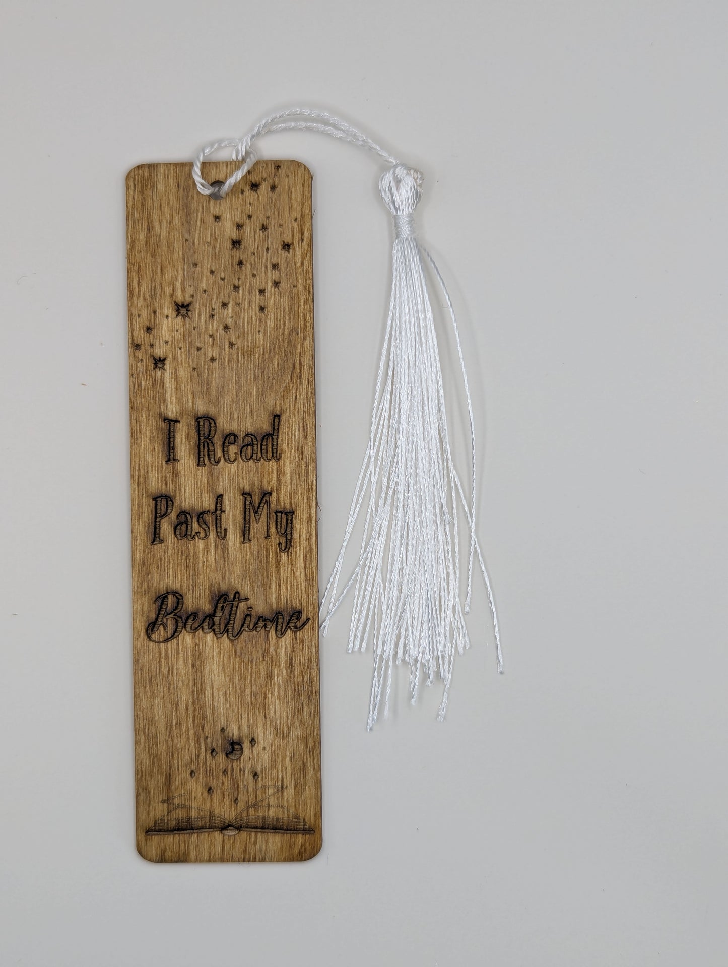alt="Witty wooden bookmark engraved with ‘I Read Past my bedtime"