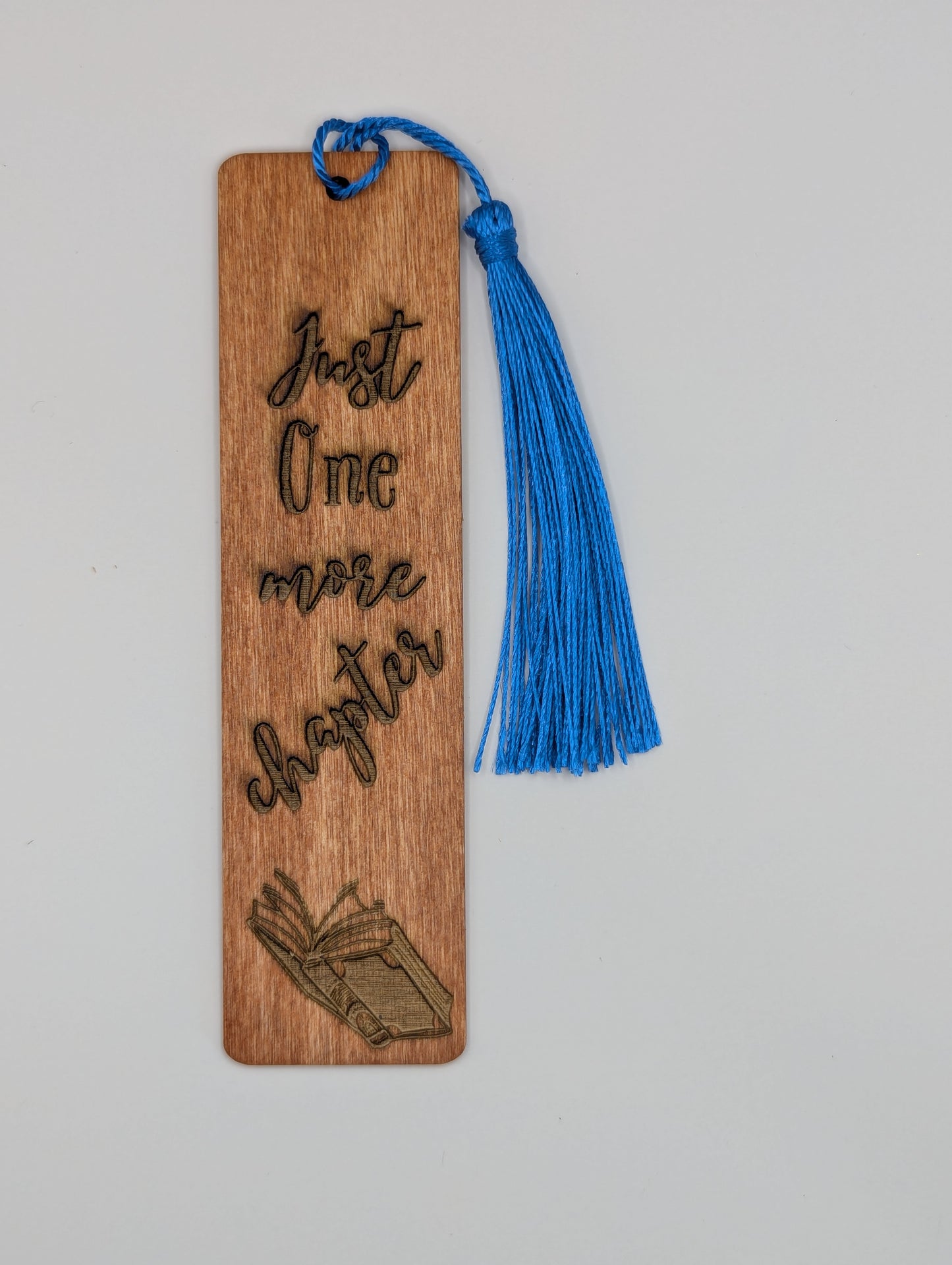 alt="Witty wooden bookmark engraved with 'Just One More Chapter’"