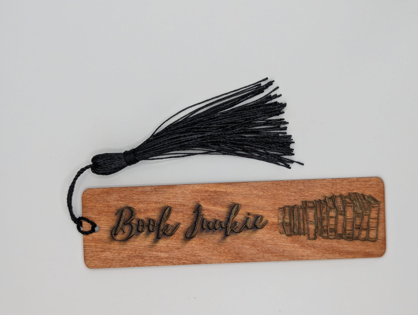 alt="Snarky wooden bookmark engraved with ‘Book Junkie’"