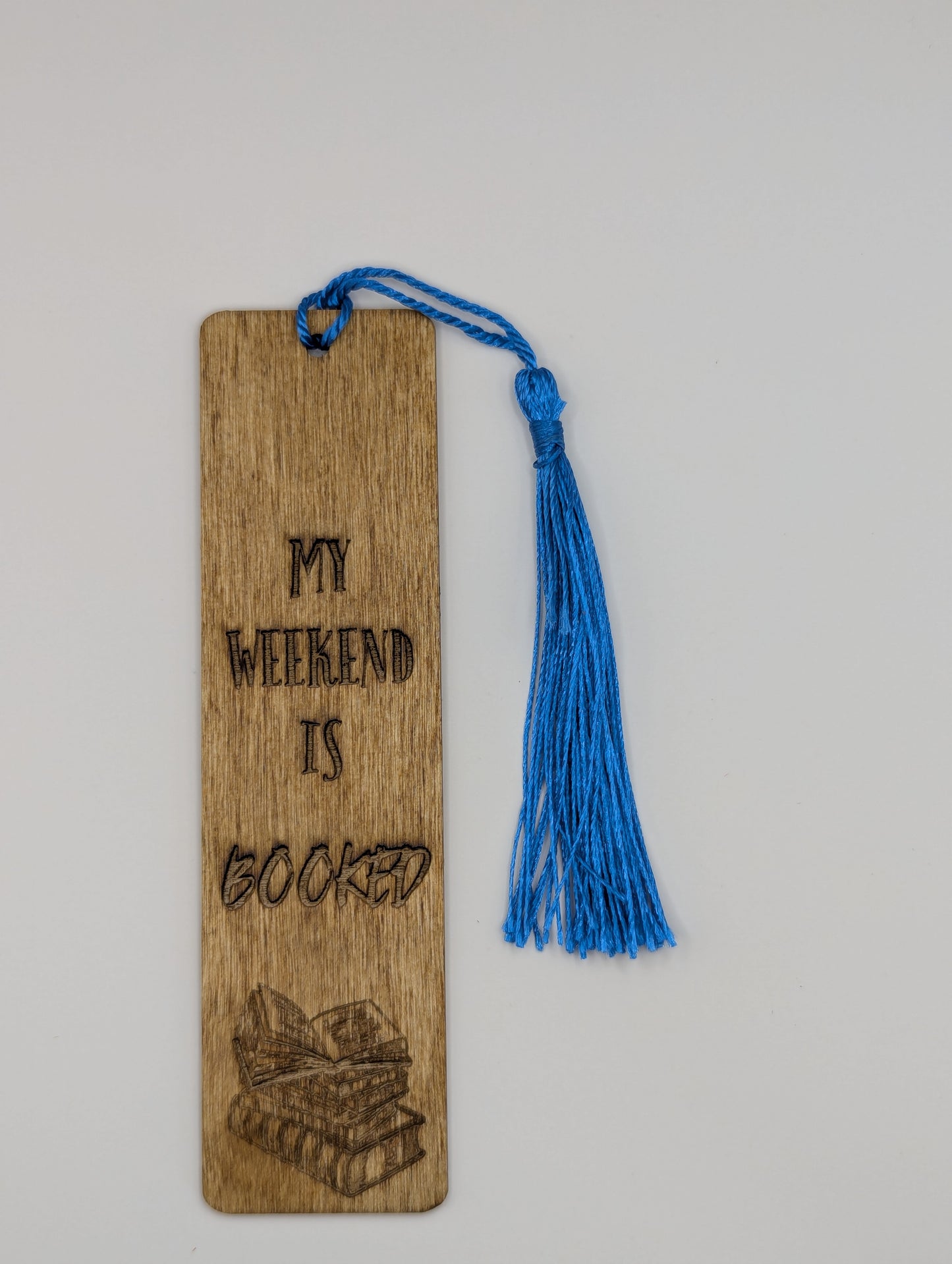 alt="Witty wooden bookmark engraved with ‘Weekend is booked'"