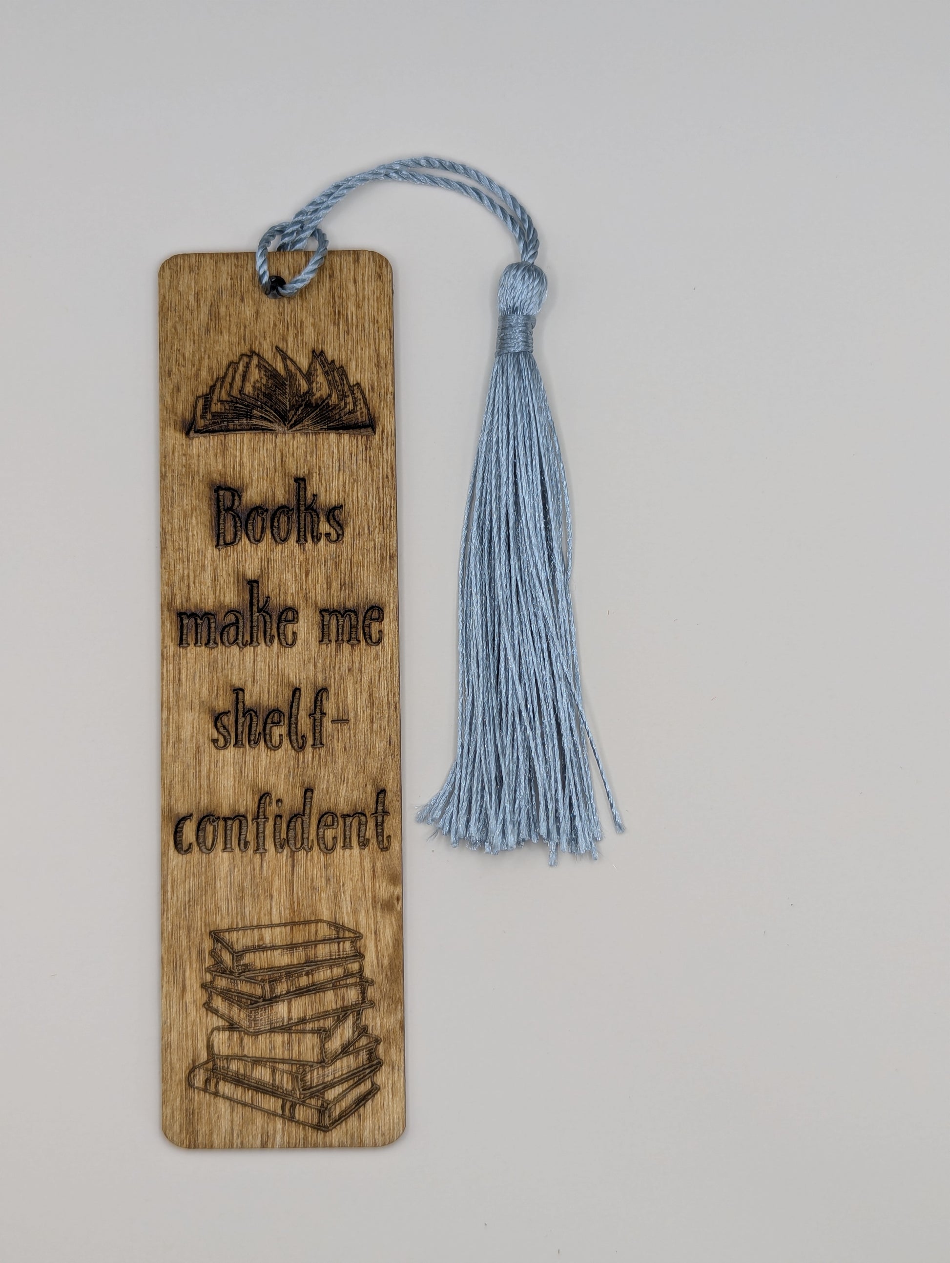 alt="Witty wooden bookmark engraved with ‘books make me shelf-confident’"
