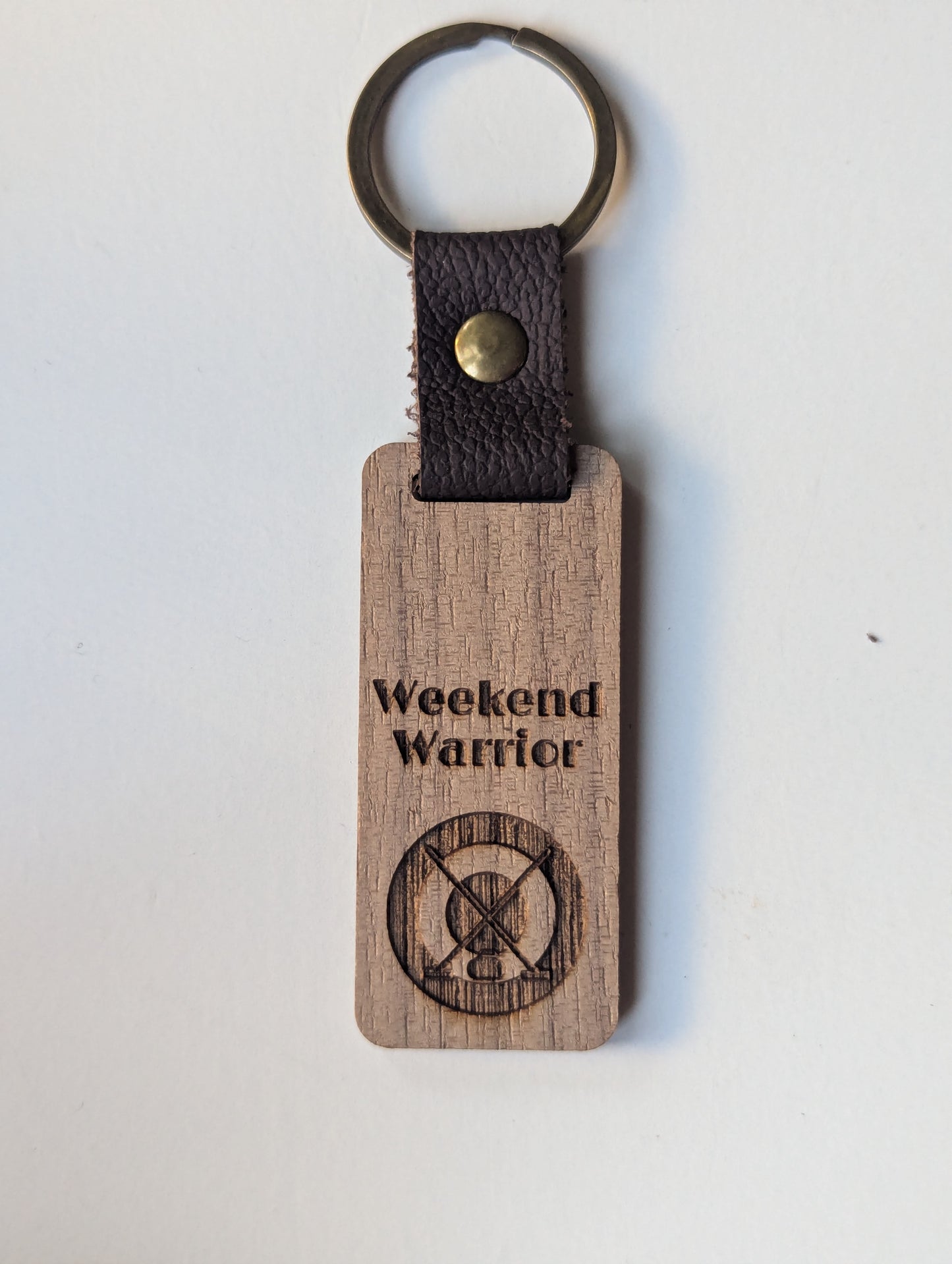 Wooden keychain with 'Weekend Warrior' engraving on a white background