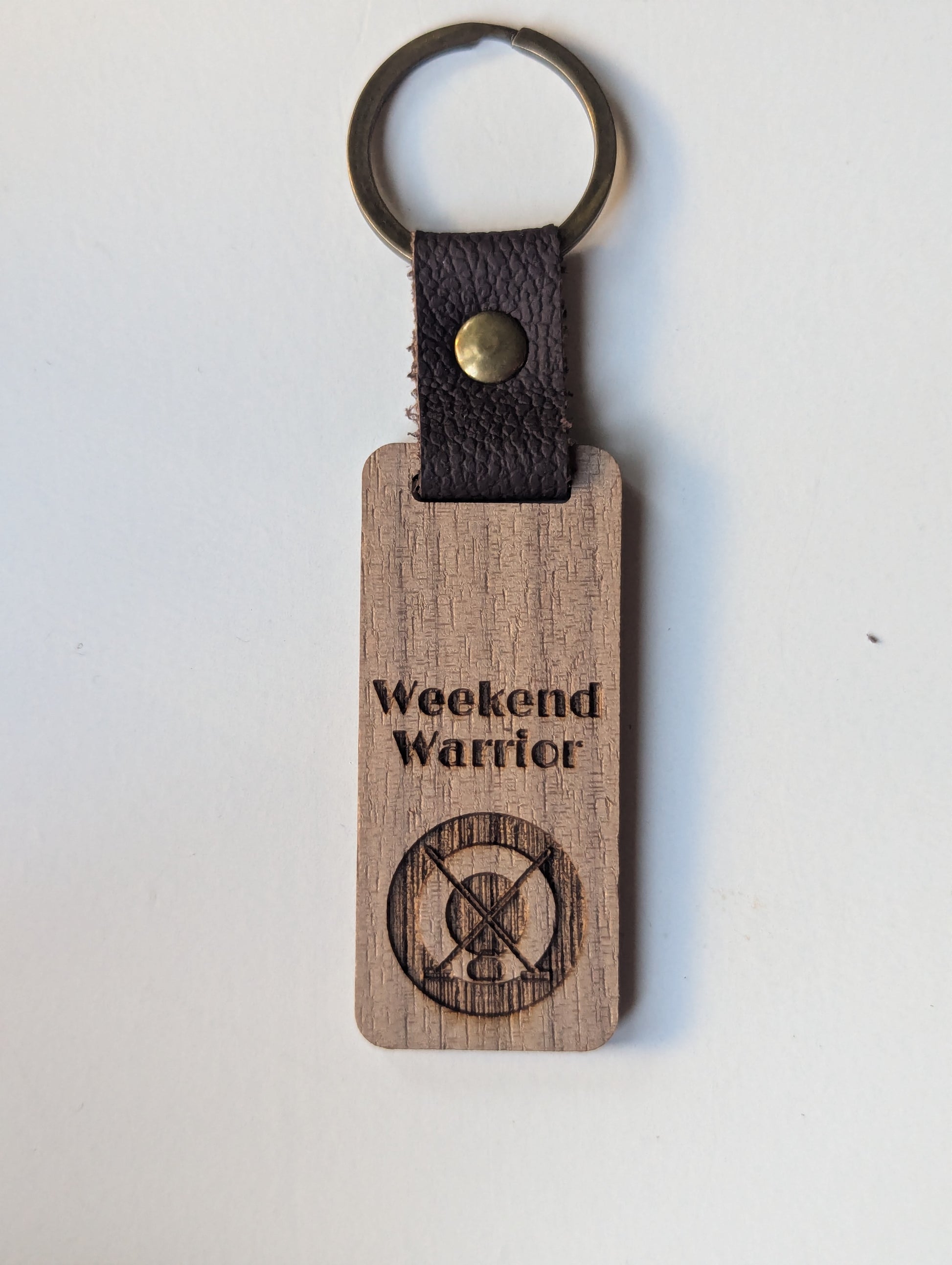 Wooden keychain with 'Weekend Warrior' engraving on a white background